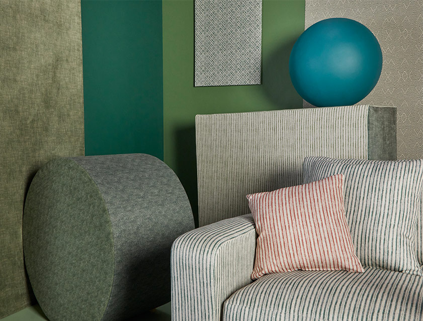 Stockbridge 2.5 seater sofa in Spill Resistant Sussex Stripe Forest and Brick with background in mixed fabrics